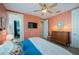 Bright bedroom with a view into another room, dresser and blue accents at 2201 Avenue C, Bradenton Beach, FL 34217