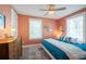 Cozy bedroom with a blue bed, patterned rug, and ample natural light from two windows at 2201 Avenue C, Bradenton Beach, FL 34217