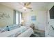 Bright bedroom with neutral walls, ceiling fan, and art providing a comfortable and stylish space at 2201 Avenue C, Bradenton Beach, FL 34217