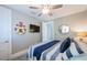 Nautical-themed bedroom featuring comfortable bedding, ceiling fan, TV, and playful decor, creating a fun and inviting space at 2201 Avenue C, Bradenton Beach, FL 34217