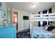Comfortable bunk beds with a colorful rug and vibrant blue dresser, offering a playful ' room at 2201 Avenue C, Bradenton Beach, FL 34217