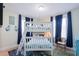 bedroom with white bunk beds, stylish decor, and matching blue accents at 2201 Avenue C, Bradenton Beach, FL 34217