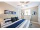 Cozy bedroom with nautical decor, plush bedding, ceiling fan and ample natural light, creating a relaxing atmosphere at 2201 Avenue C, Bradenton Beach, FL 34217