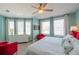 Bright primary bedroom with ample natural light, ceiling fan, and comfortable furnishings, offering a serene retreat at 2201 Avenue C, Bradenton Beach, FL 34217