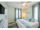 Charming bedroom features a ceiling fan, natural light, and a soothing color palette, creating a relaxing retreat at 2201 Avenue C, Bradenton Beach, FL 34217
