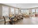 Bright dining room featuring a large table, chandelier, and direct access to outdoor balcony with waterfront views at 2201 Avenue C, Bradenton Beach, FL 34217