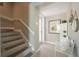 Stylish entryway with a staircase, pelican art, and a bench, creates a welcoming ambiance at 2201 Avenue C, Bradenton Beach, FL 34217