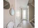 Entryway with decorative mirrors, staircase, and ample lighting creates an inviting and stylish welcome at 2201 Avenue C, Bradenton Beach, FL 34217