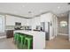 Modern kitchen with white cabinetry, stainless steel appliances, quartz countertops, and colorful backsplash, and seating at 2201 Avenue C, Bradenton Beach, FL 34217