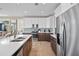 Bright kitchen featuring white cabinets, stainless steel appliances, a large sink, and a decorative backsplash at 2201 Avenue C, Bradenton Beach, FL 34217