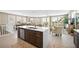 Gourmet kitchen flows into dining & living, with large island, premium appliances, and quartz countertops at 2201 Avenue C, Bradenton Beach, FL 34217