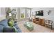 Cozy living room with coastal decor, comfortable seating, and a large TV, creating a relaxing gathering space at 2201 Avenue C, Bradenton Beach, FL 34217