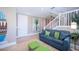 Inviting living area with a staircase, comfortable sofa, and tasteful decor, creating a cozy and stylish atmosphere at 2201 Avenue C, Bradenton Beach, FL 34217