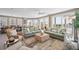 Bright and airy living room with comfortable seating, large windows, and access to a balcony with ocean views at 2201 Avenue C, Bradenton Beach, FL 34217