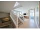 Bright living room showcases an open floor plan, stairs, and a view into the primary bedroom at 2201 Avenue C, Bradenton Beach, FL 34217