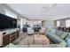 Open-concept living space featuring a modern kitchen with a breakfast bar, a comfortable living area, and a dining area at 2201 Avenue C, Bradenton Beach, FL 34217