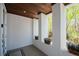 Covered porch with wood ceiling, decorative planters, and natural light creating an inviting space at 2201 Avenue C, Bradenton Beach, FL 34217