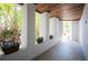 Inviting covered porch with wood ceiling, decorative plants, and natural light creating an inviting space at 2201 Avenue C, Bradenton Beach, FL 34217