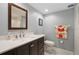 Bathroom features a modern vanity with mirror, decorative towels, and tile flooring at 2503 Beneva Rd # 7, Sarasota, FL 34232