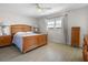 Bright bedroom with wood flooring, a wooden bed frame, and a window providing natural light at 2503 Beneva Rd # 7, Sarasota, FL 34232