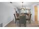 Open dining area with glass table, pendant lighting, and views of the adjacent living spaces at 2503 Beneva Rd # 7, Sarasota, FL 34232