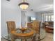 Inviting dining area with glass-top table, chandelier, and comfortable seating at 2503 Beneva Rd # 7, Sarasota, FL 34232