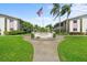 Forest Lakes entrance with manicured lawn, mature trees and sign welcoming residents to the community at 2503 Beneva Rd # 7, Sarasota, FL 34232