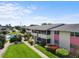 Exterior condo building with a community pool and manicured landscaping at 2503 Beneva Rd # 7, Sarasota, FL 34232