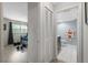 Hallway view into bedroom with weights, and bathroom with tiled floors, toilet, and vanity at 2503 Beneva Rd # 7, Sarasota, FL 34232