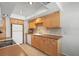 Functional kitchen with wood cabinets, neutral countertops, and modern appliances at 2503 Beneva Rd # 7, Sarasota, FL 34232