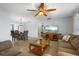 Open-concept living room and dining area with a glass-top coffee table, wood floors, and neutral paint at 2503 Beneva Rd # 7, Sarasota, FL 34232