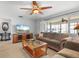 Comfortable living room with a ceiling fan, wood flooring, and a large window offering natural light at 2503 Beneva Rd # 7, Sarasota, FL 34232