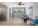 Bright living room with wood-look flooring, ceiling fan, and sunny window with comfortable seating at 2503 Beneva Rd # 7, Sarasota, FL 34232