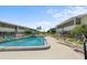Community pool area with well-maintained lawn chairs, lush landscaping, and inviting blue water for residents' enjoyment at 2503 Beneva Rd # 7, Sarasota, FL 34232