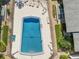 Aerial view of a community pool with lounge chairs and landscaped surroundings at 2503 Beneva Rd # 7, Sarasota, FL 34232