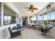 Relaxing sunroom with ceiling fan, tile flooring, and large windows at 2503 Beneva Rd # 7, Sarasota, FL 34232