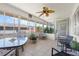 Cozy sunroom featuring tile floor, ceiling fan, and abundant natural light at 2503 Beneva Rd # 7, Sarasota, FL 34232