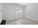 This is a simple bedroom with new flooring and a bright window showing an outside view at 2652 26Th St, Sarasota, FL 34234