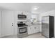 Modern kitchen with stainless steel appliances, sleek cabinetry, and stylish backsplash at 2652 26Th St, Sarasota, FL 34234