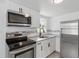 Modern kitchen featuring stainless steel appliances, sleek cabinets, and a stylish backsplash at 2652 26Th St, Sarasota, FL 34234