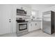 Modern kitchen with stainless steel appliances, sleek cabinetry, and stylish backsplash at 2652 26Th St, Sarasota, FL 34234