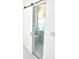 Neat, all-white bathroom featuring modern sliding door, toilet, and hardware at 2702 45Th S St, Gulfport, FL 33711