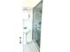 Cozy bathroom featuring a pedestal sink, modern vanity mirror, and a glass-enclosed shower at 2702 45Th S St, Gulfport, FL 33711