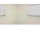 Bright bedroom featuring white walls, trim, and two windows with white blinds at 2702 45Th S St, Gulfport, FL 33711