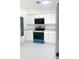 Updated kitchen with stainless steel appliances, white cabinets, and modern lighting at 2702 45Th S St, Gulfport, FL 33711