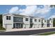 Charming row of new townhomes with grey and blue exterior and integrated garages at 2714 Newbern Banks Dr, Bradenton, FL 34208
