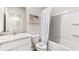 Well-lit bathroom featuring a white vanity, marble countertop, and a tub/shower combo with white shower curtain at 2726 Newbern Banks Dr, Bradenton, FL 34208