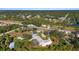 Aerial view of property marked with yellow outline, nearby houses, and natural surroundings at 31 Twig Ct, Port Charlotte, FL 33954