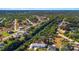 High-angle view featuring houses amidst winding waterways, roads and lush greenery and neighborhood at 31 Twig Ct, Port Charlotte, FL 33954