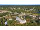 High-angle shot showcasing residences by waterways, adjacent to roadways and dense greenery at 31 Twig Ct, Port Charlotte, FL 33954